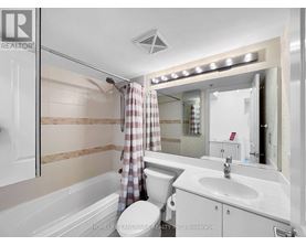 A modern bathroom with a walk-in shower and a vanity with a sink.