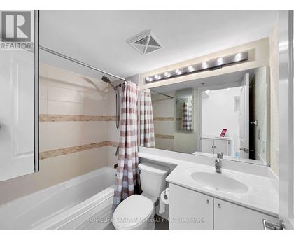 A modern bathroom with a walk-in shower and a vanity with a sink.