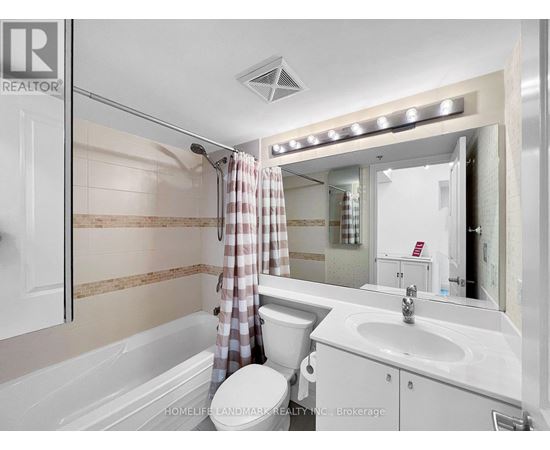 A modern bathroom with a walk-in shower and a vanity with a sink.