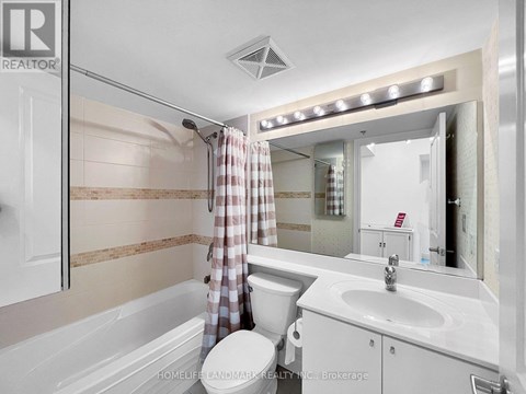 A modern bathroom with a walk-in shower and a vanity with a sink.