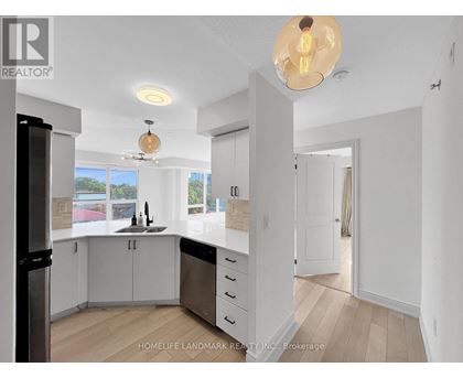 A modern kitchen with white cabinets and a large island.
