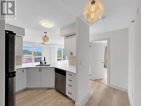A modern kitchen with white cabinets and a large island.