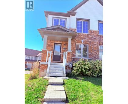 A house with a brick facade and a white porch.