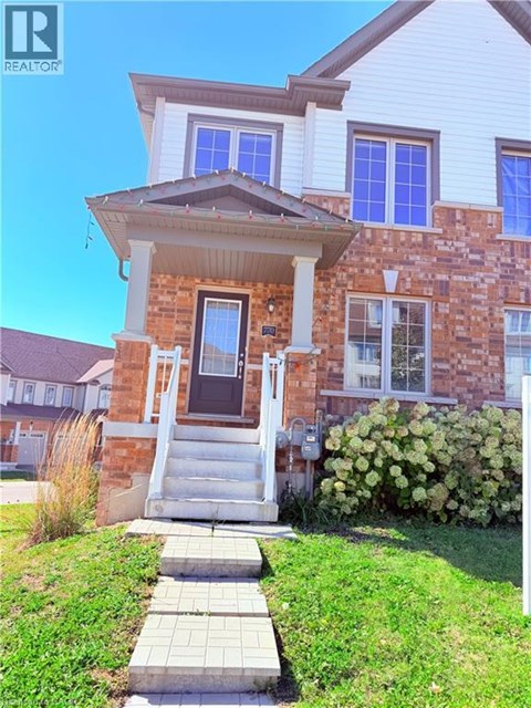 A house with a brick facade and a white porch.