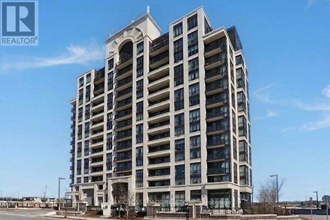 A tall residential building with a clear blue sky in the background.
