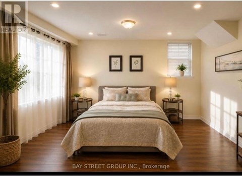 A bedroom with a large bed and two nightstands.