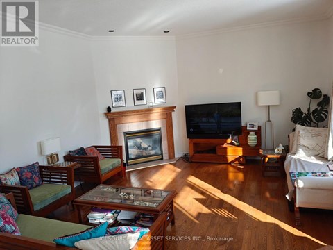 A living room with a fireplace and a TV.