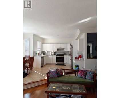 A well-lit kitchen with a dining table and chairs.