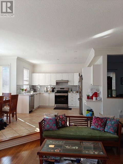 A well-lit kitchen with a dining table and chairs.