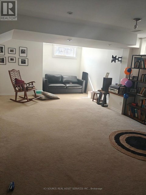 A living room with a couch, chair, and rug.