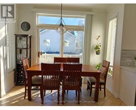 A dining room with a table and chairs.