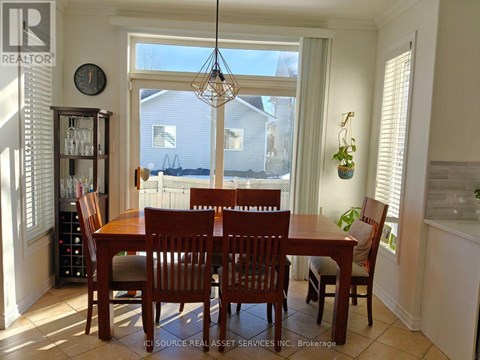 A dining room with a table and chairs.