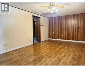 A room with wooden floors and a ceiling fan.