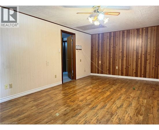 A room with wooden floors and a ceiling fan.