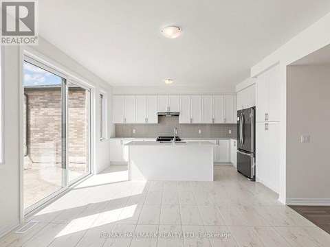 A modern kitchen with white cabinets and a large island.