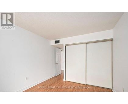 A white room with a sliding door and a small white door in the background.
