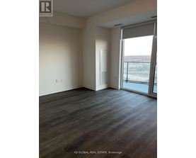 A room with a sliding glass door leading to a balcony.