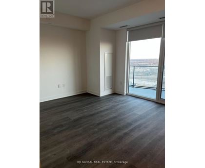 A room with a sliding glass door leading to a balcony.