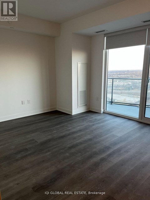 A room with a sliding glass door leading to a balcony.