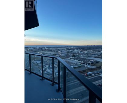 A view from a high-rise building overlooking a cityscape at dusk.