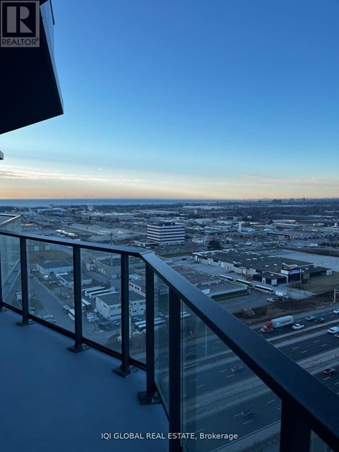 A view from a high-rise building overlooking a cityscape at dusk.
