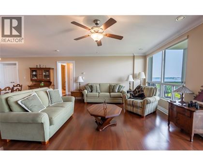 A living room with a green couch and a wooden coffee table.