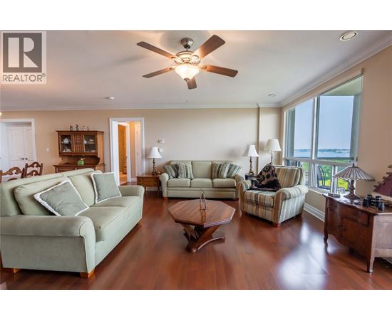 A living room with a green couch and a wooden coffee table.