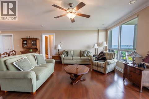 A living room with a green couch and a wooden coffee table.