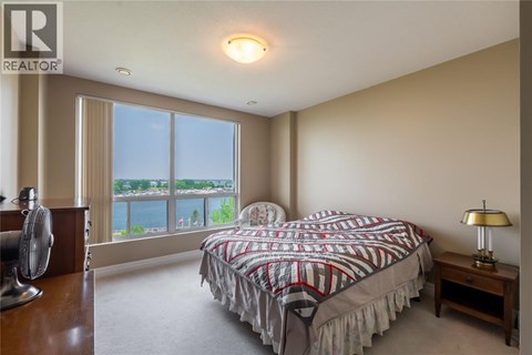 A bedroom with a large bed and a fan.