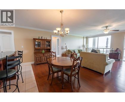 A dining room with a table set for six.