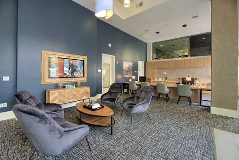A room with a blue wall and a painting on it.