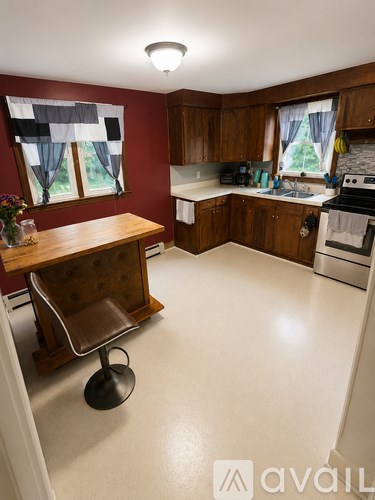 A kitchen with a wooden table and a white stove.