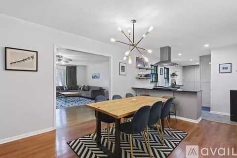 A dining room with a wooden table and chairs.