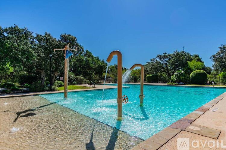 A pool with a slide and a diving board.