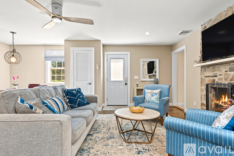 A living room with a grey couch and a blue chair.