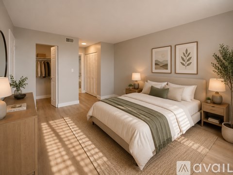 A well-lit bedroom with a large bed and a wooden dresser.