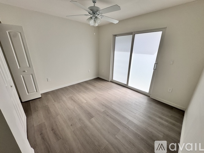 A bedroom with a bed, dresser, and television.