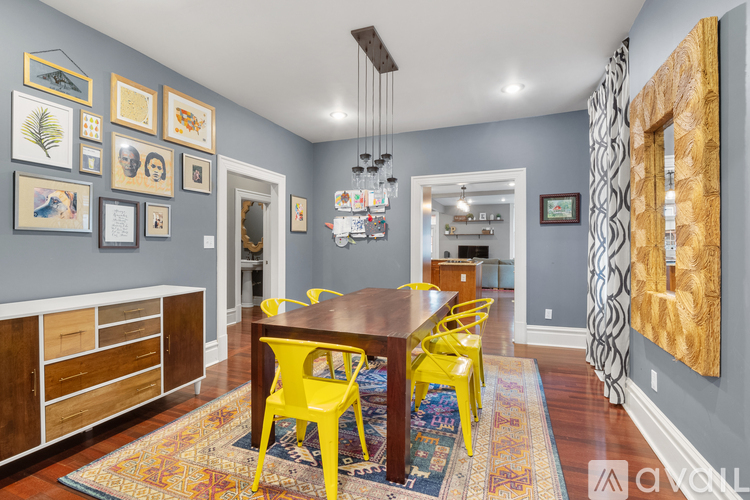 A dining room with a wooden table and yellow chairs.