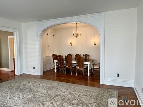 A dining room with a table set for six.