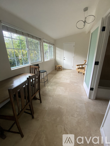 A room with a table and chairs in it.
