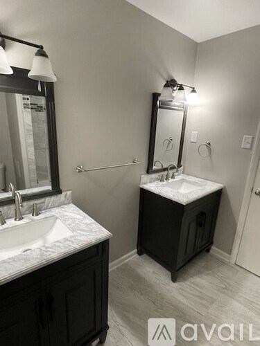 A bathroom with a sink, mirror, and a cabinet.
