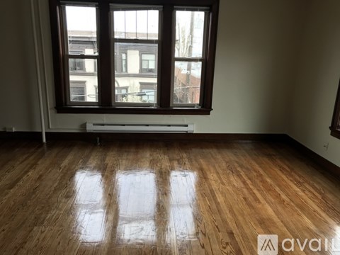 A room with wooden floors and a window.