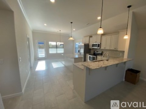 A kitchen with a counter and cabinets is available for rent.
