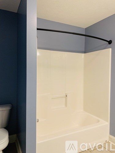A bathroom with a white tub and a toilet.