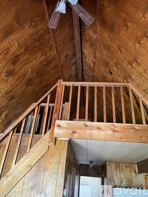A wooden staircase with a railing is in the foreground of this image.