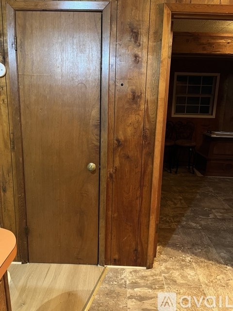 A wooden door with a handle and a lock.