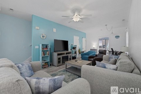 A living room with a grey couch and a television.