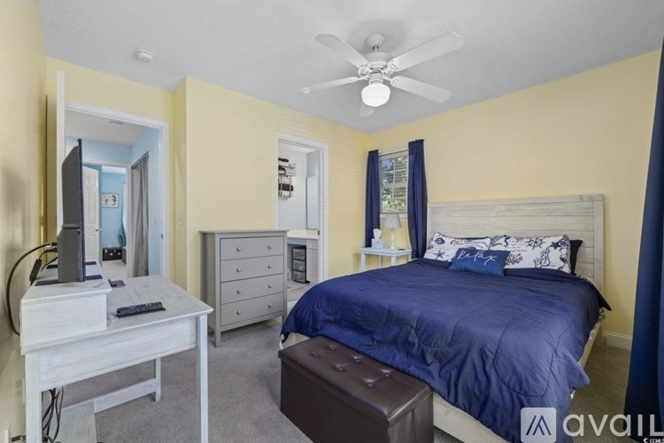 A bedroom with a bed, dresser, and mirror.