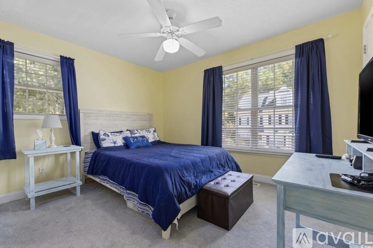 A bedroom with a bed, nightstand, and a television.