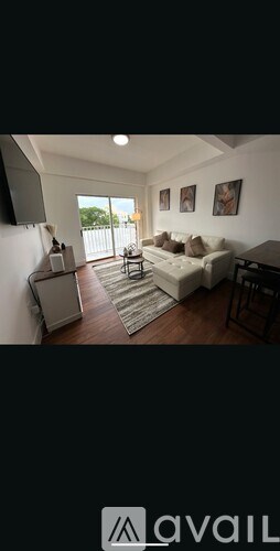 A living room with a couch, a chair, and a coffee table.